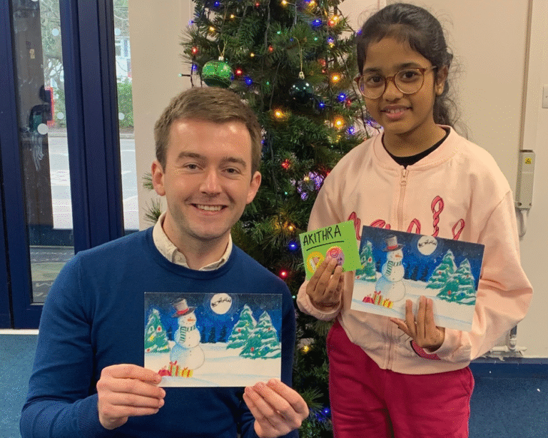 Tom Rutland MP with a winner of his Christmas card competition.