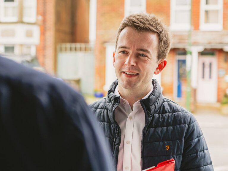 Tom Rutland MP at a resident's door.